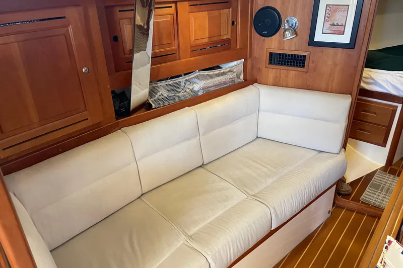 Slide: The Image of Interior of 2004 Tartan 3700 yacht with beige sofa and wooden cabinetry. - 13
