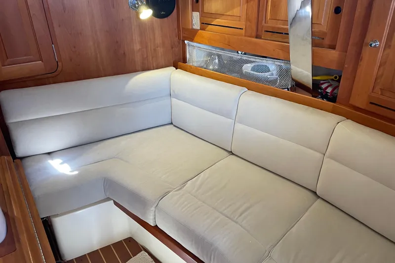 Slide: The Image of Cozy interior of 2004 Tartan 3700 sailboat with beige cushioned seating. - 14