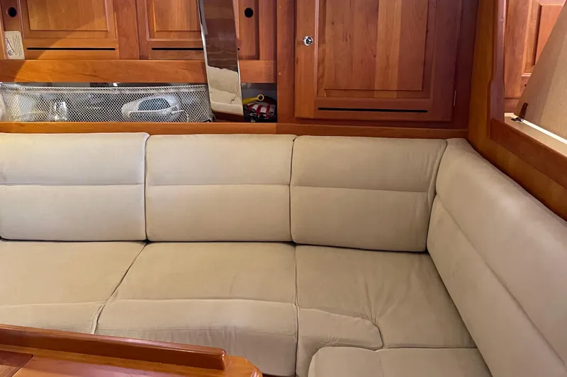 Slide: The Image of Cozy interior of 2004 Tartan 3700 yacht with beige seating and wooden cabinetry. - 15