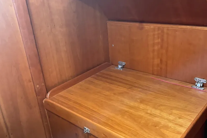 Slide: The Image of Wooden interior of a 2004 Tartan 3700 sailboat, featuring a foldable table. - 21