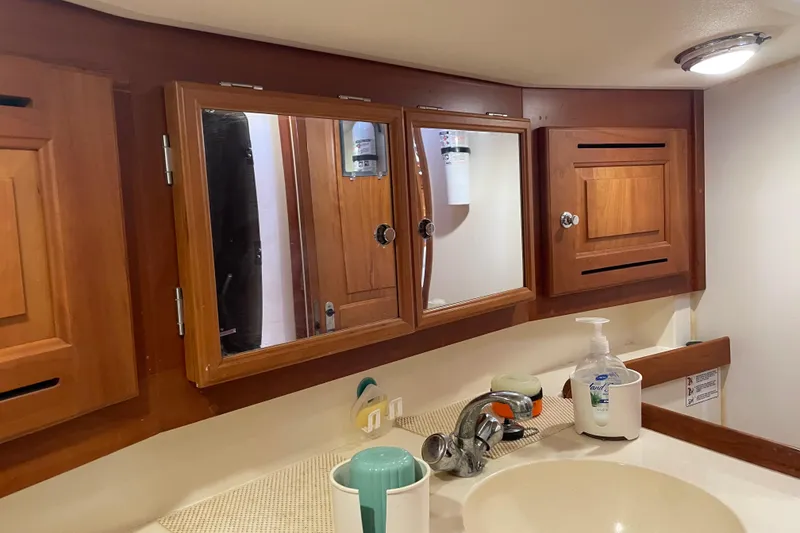 Slide: The Image of Wooden bathroom cabinets and sink in a 2004 Tartan 3700 yacht interior. - 25