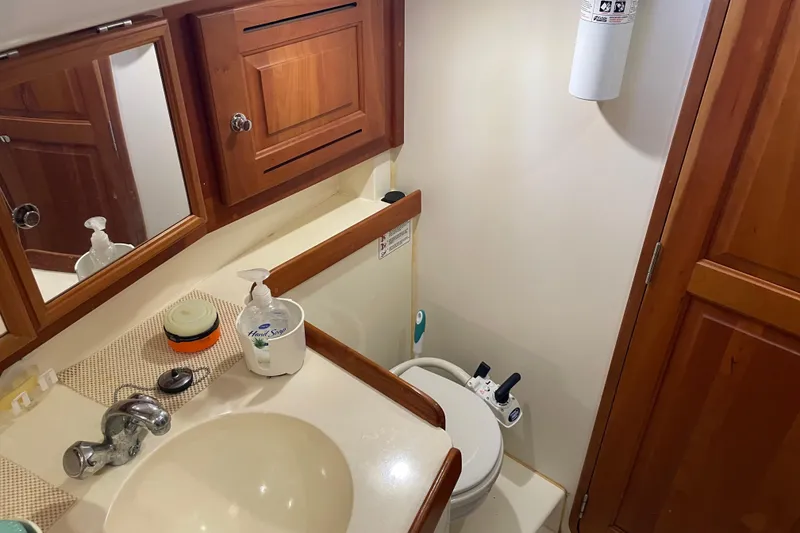 Slide: The Image of Bathroom interior of 2004 Tartan 3700 yacht with sink, mirror, and toilet. - 29