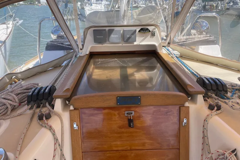 Slide: The Image of Cockpit of 2004 Tartan 3700 sailboat with ropes and wooden hatch. - 3