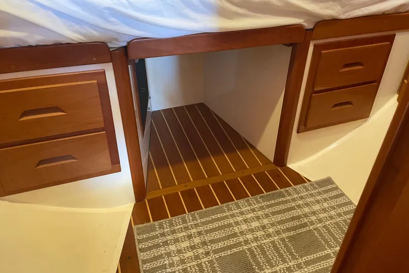 Slide: The Image of Interior of 2004 Tartan 3700 sailboat with wooden drawers and striped flooring. - 33