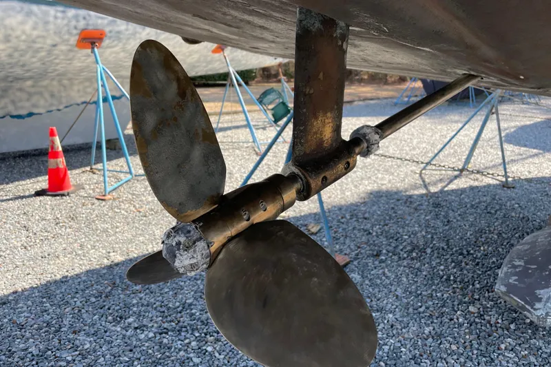 Slide: The Image of Propeller of 2004 Tartan 3700 sailboat on gravel with stands and traffic cone. - 42