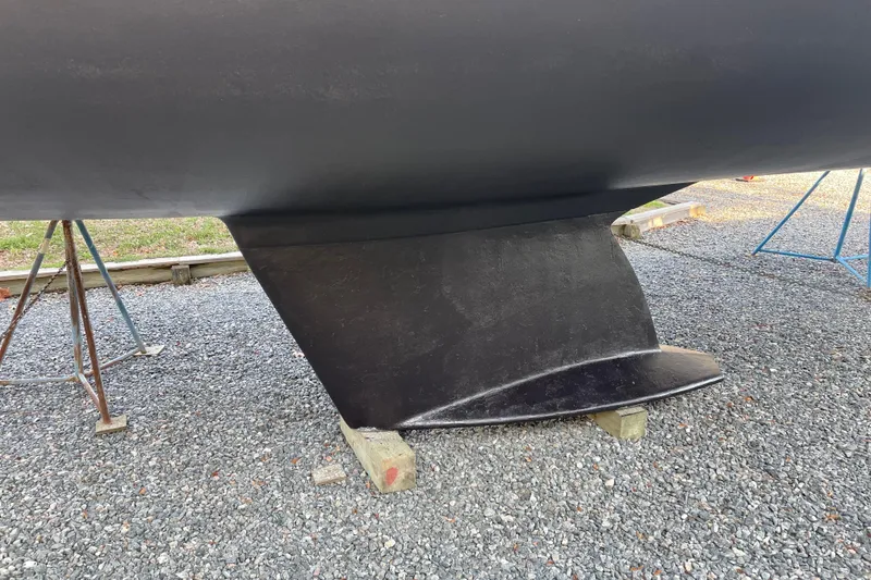 Slide: The Image of Keel of a 2004 Tartan 3700 sailboat on gravel with supports. - 44