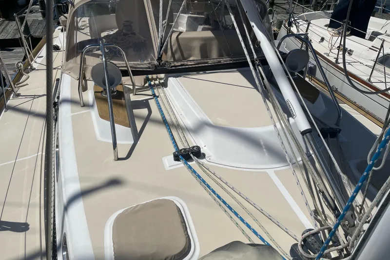 Slide: The Image of 2004 Tartan 3700 sailboat deck with rigging and winches in marina setting. - 6