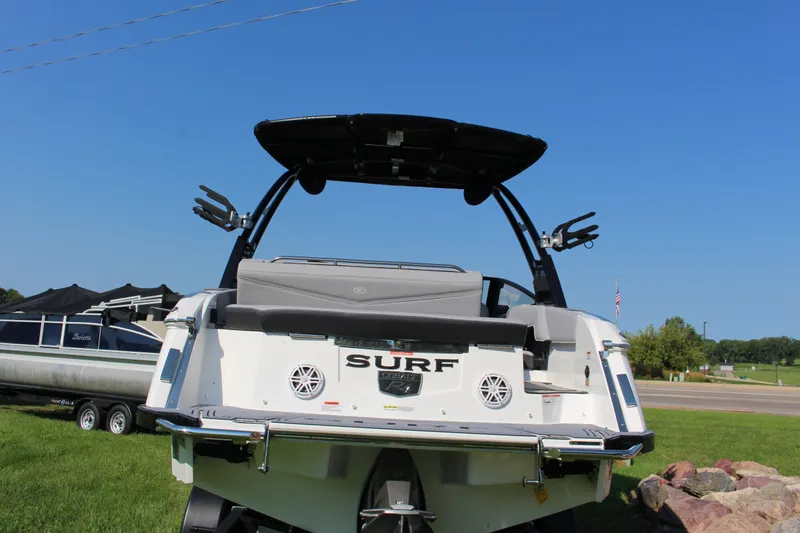 Slide: The Image of 2025 Cobalt R4 Surf boat with sleek design and modern features, parked outdoors. - 19