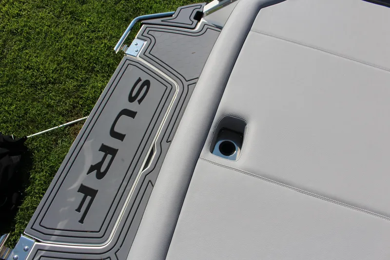 Slide: The Image of 2025 Cobalt R4 Surf boat deck with "SURF" branding and sleek design. - 23