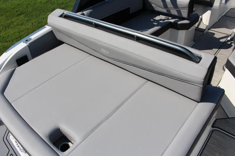 Slide: The Image of 2025 Cobalt R4 Surf boat interior with gray seating and cup holder. - 24