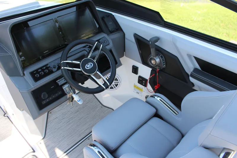 Slide: The Image of 2025 Cobalt R4 Surf boat cockpit with modern steering and dual screens. - 27