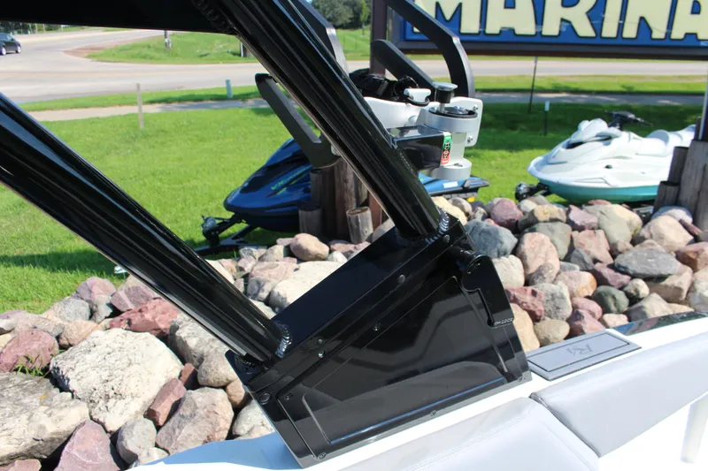 Slide: The Image of 2025 Cobalt R4 Surf boat detail with sleek black frame near marina. - 42