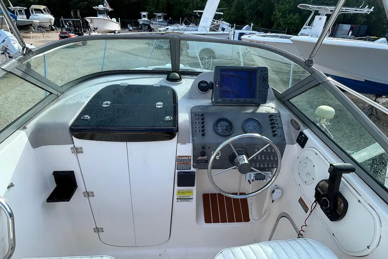 Slide: The Image of 2003 Trophy Walkaround Pro boat cockpit with steering wheel and navigation equipment. - 3