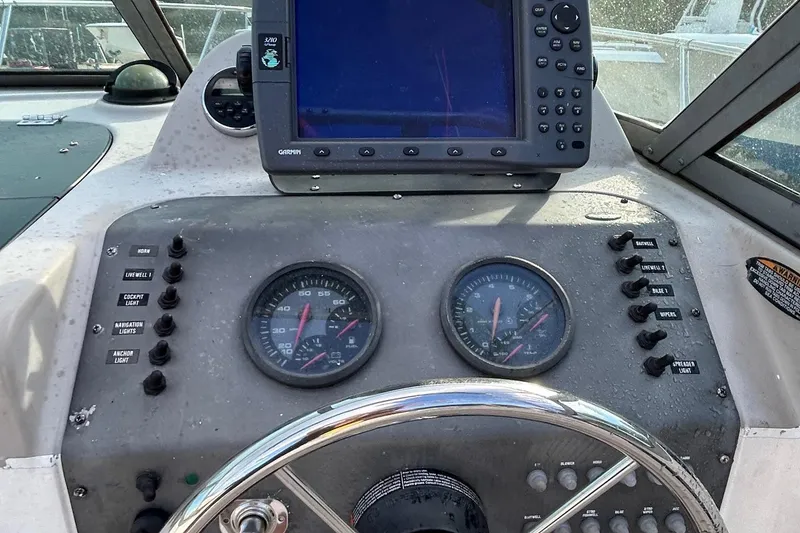Slide: The Image of 2003 Trophy Walkaround Pro boat dashboard with Garmin GPS and gauges. - 4