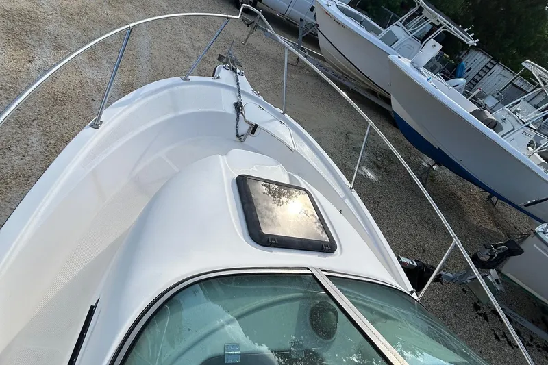 Slide: The Image of 2003 Trophy Walkaround Pro boat on display, featuring sleek design and sturdy railings. - 5