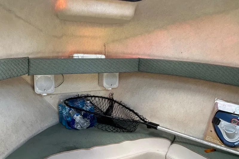 Slide: The Image of Interior of a 2003 Trophy Walkaround Pro boat with fishing net and water bottles. - 8