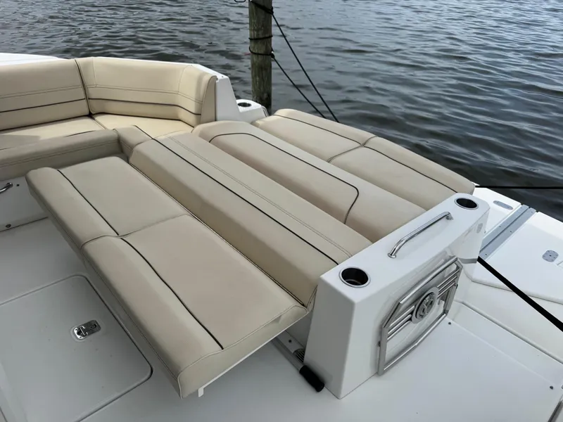 Slide: The Image of 2017 Cruisers Yachts 45 Cantius boat with beige seating, docked by the water. - 10
