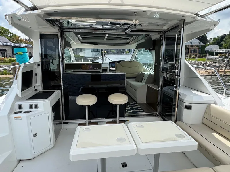Slide: The Image of 2017 Cruisers Yachts 45 Cantius interior with seating, tables, and open deck view. - 12