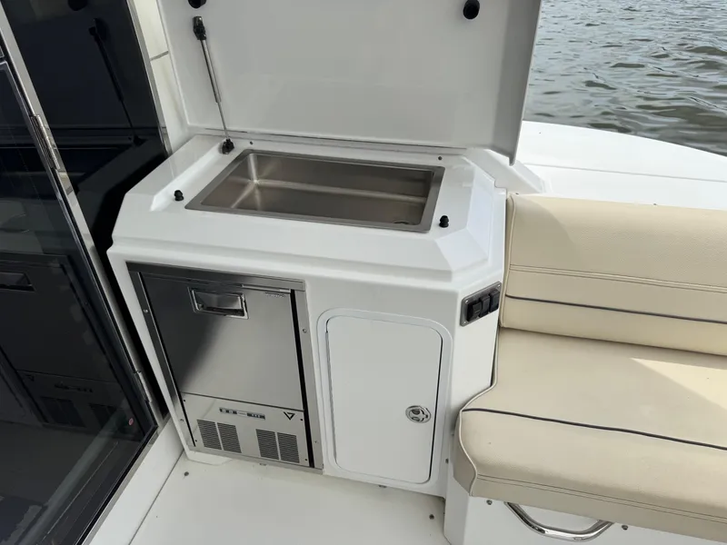 Slide: The Image of Outdoor kitchen area on 2017 Cruisers Yachts 45 Cantius, featuring a sink and seating. - 14