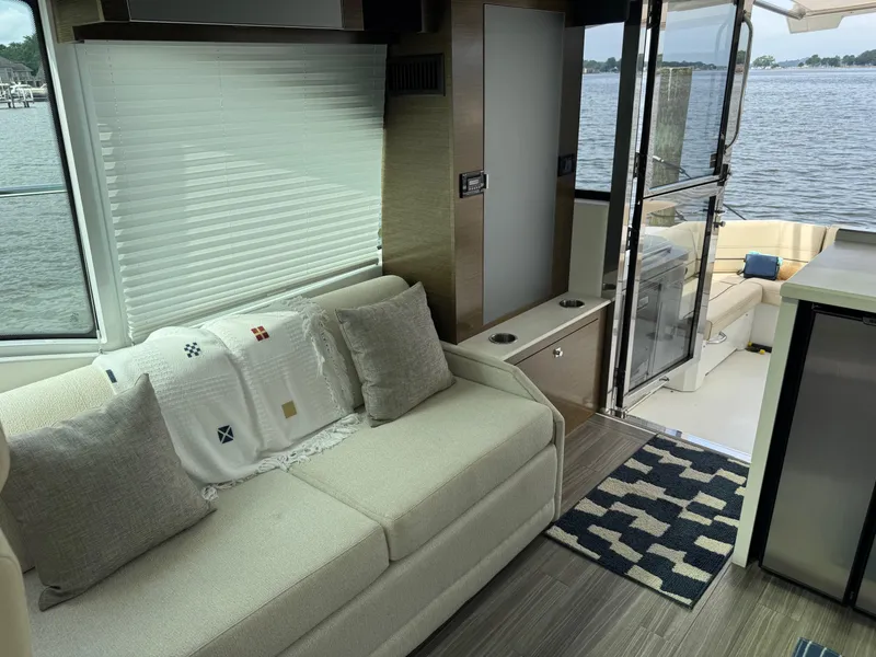 Slide: The Image of Interior of 2017 Cruisers Yachts 45 Cantius with cozy seating and lake view. - 21