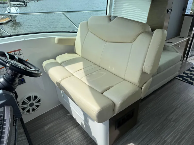 Slide: The Image of Helm seating on 2017 Cruisers Yachts 45 Cantius, featuring beige upholstery and modern design. - 22
