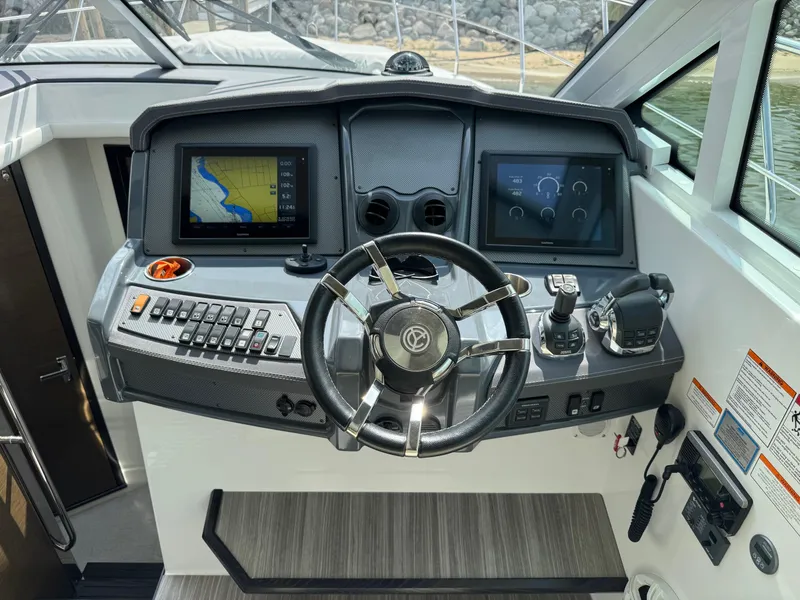 Slide: The Image of Helm of 2017 Cruisers Yachts 45 Cantius with navigation screens and controls. - 23