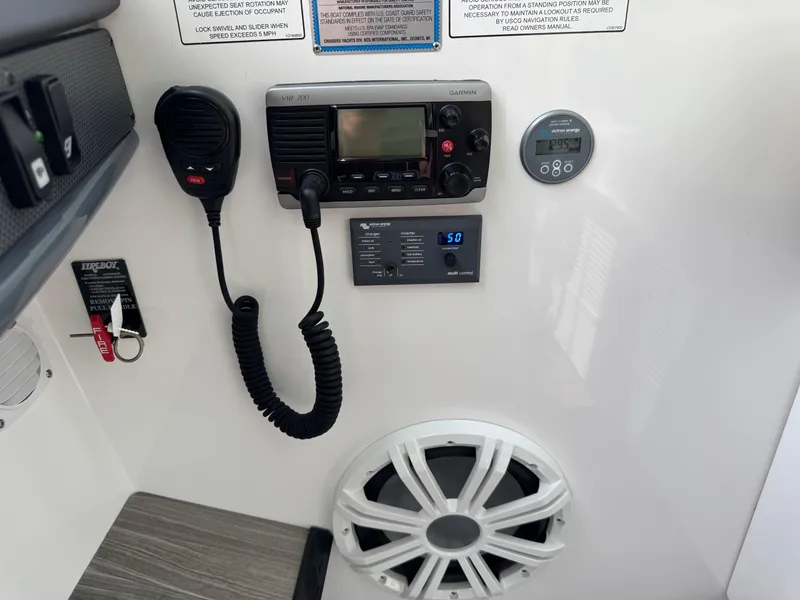 Slide: The Image of Control panel of 2017 Cruisers Yachts 45 Cantius with radio, speaker, and gauges. - 24