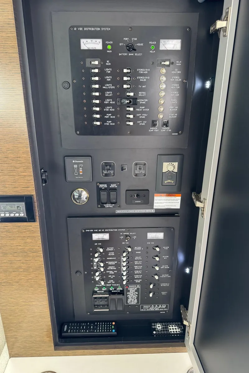 Slide: The Image of Electrical control panel inside 2017 Cruisers Yachts 45 Cantius, featuring switches and circuit breakers. - 26