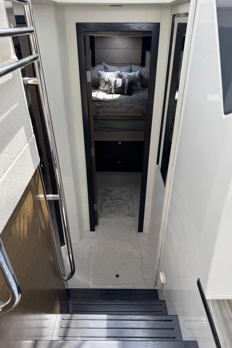 Slide: The Image of Interior view of 2017 Cruisers Yachts 45 Cantius, featuring a cozy cabin with bed. - 27