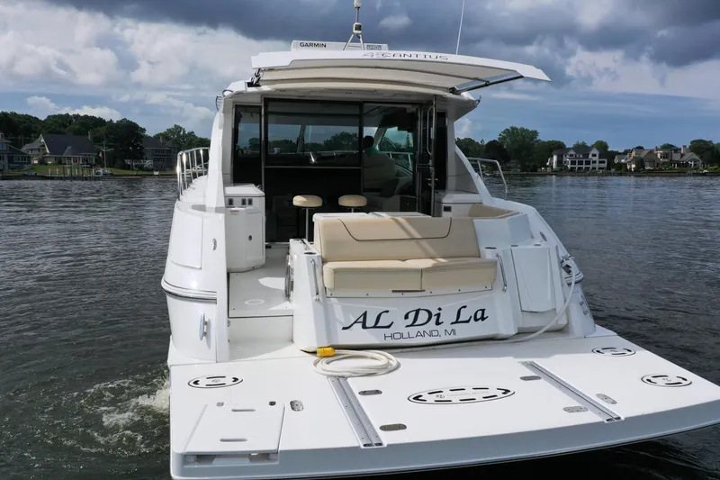 Slide: The Image of 2017 Cruisers Yachts 45 Cantius on water, rear view, with "AL Di La" name visible. - 3