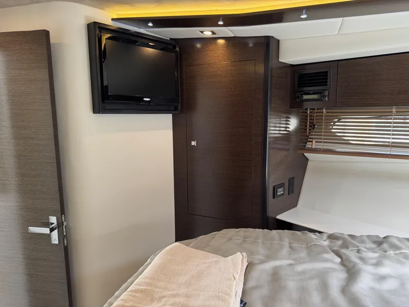 Slide: The Image of Interior of 2017 Cruisers Yachts 45 Cantius with TV and modern wood finishes. - 37