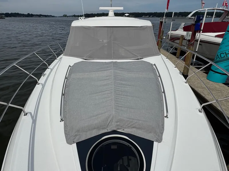 Slide: The Image of 2017 Cruisers Yachts 45 Cantius docked, featuring sleek design and covered deck area. - 6