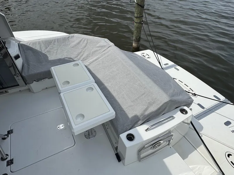 Slide: The Image of 2017 Cruisers Yachts 45 Cantius deck with covered seating and table, docked by water. - 7