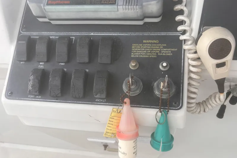 Slide: The Image of Control panel of a 1994 Carver 350 boat with switches and microphone. - 11