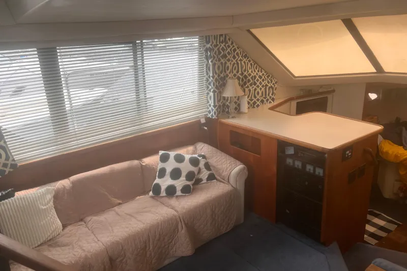 Slide: The Image of Interior of a 1994 Carver 350 yacht with cozy seating and nautical decor. - 30