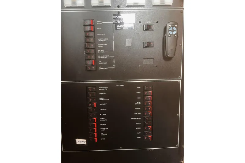 Slide: The Image of Electrical control panel of a 1994 Carver 350 boat, featuring labeled switches and controls. - 32
