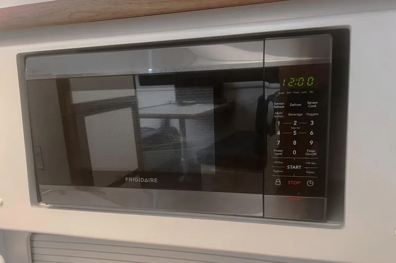 Slide: The Image of Frigidaire microwave in a 1994 Carver 350 yacht kitchen, displaying 12:00 on the digital clock. - 37