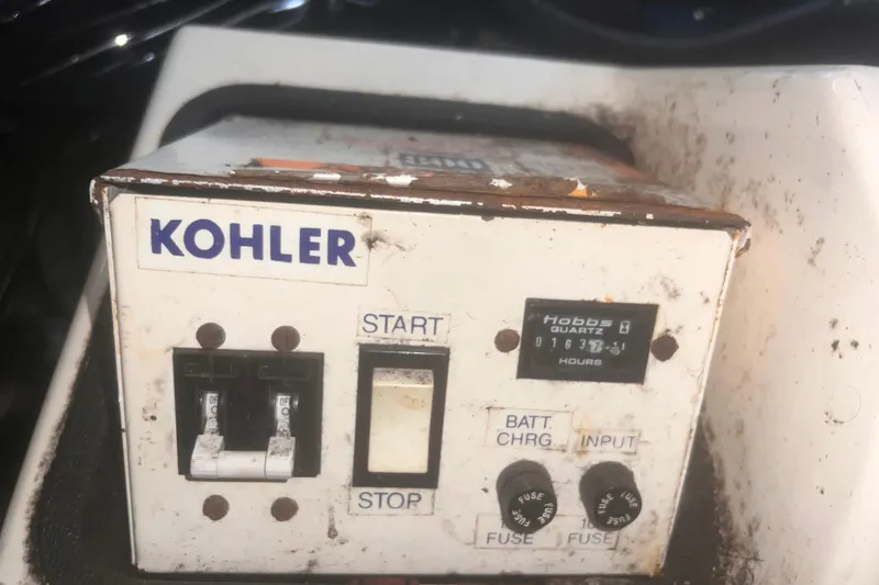 Slide: The Image of Kohler control panel on a 1994 Carver 350 boat, showing switches and hour meter. - 50