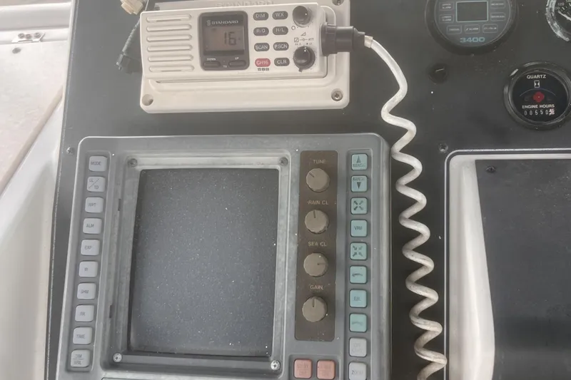 Slide: The Image of 1994 Carver 350 boat dashboard with radio and navigation controls. - 12