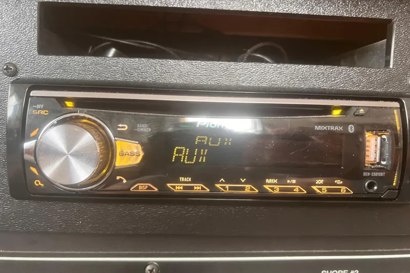 Slide: The Image of Pioneer car stereo system in a 1994 Carver 350, displaying "AUX" mode. - 16