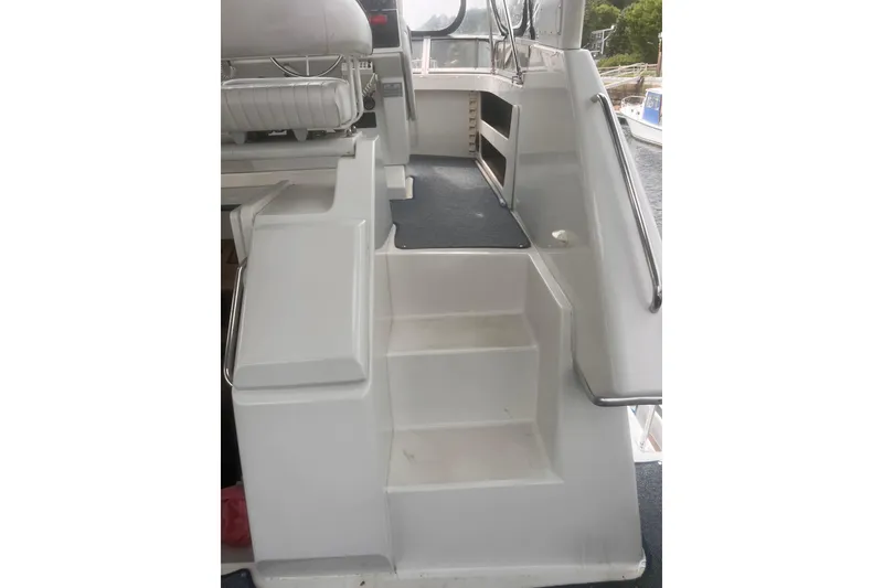Slide: The Image of Interior stairs of a 1994 Carver 350 yacht, featuring white steps and railing. - 24