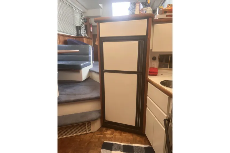 Slide: The Image of 1994 Carver 350 yacht interior with kitchenette and seating area. - 33