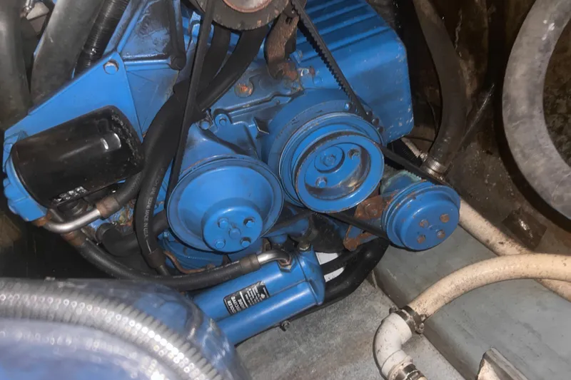 Slide: The Image of Blue engine of a 1994 Carver 350 boat, showing belts and hoses. - 46