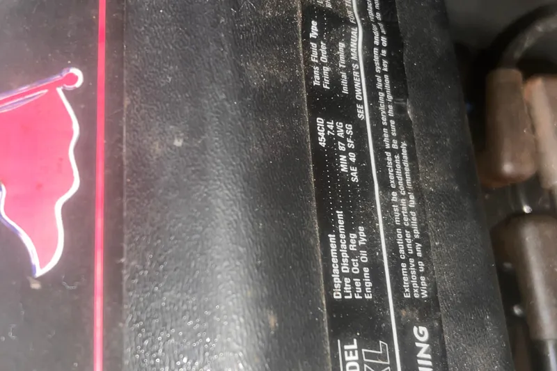 Slide: The Image of Close-up of a 1994 Carver 350 engine label with specifications and warnings. - 53