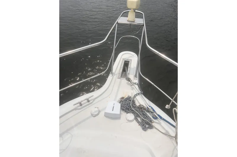 Slide: The Image of Bow of 1994 Carver 350 yacht with anchor chain and calm water view. - 7