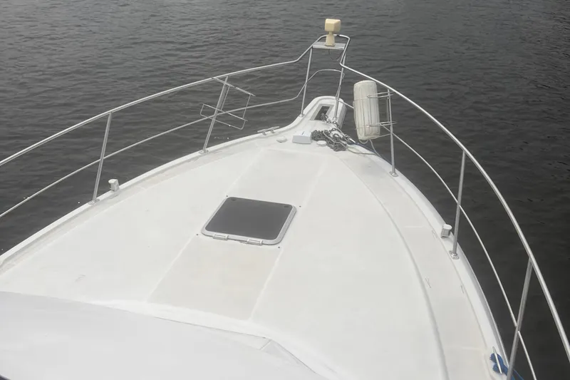 Slide: The Image of Bow view of 1994 Carver 350 yacht on calm water. - 8