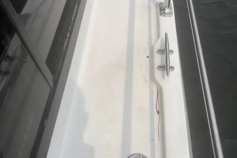 Slide: The Image of 1994 Carver 350 boat deck with cleat and railing, close-up view. - 9