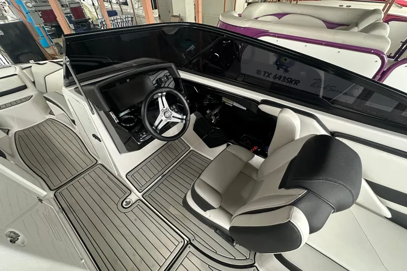 Slide: The Image of 2020 Yamaha Boats 242SE interior with sleek dashboard and comfortable seating. - 10