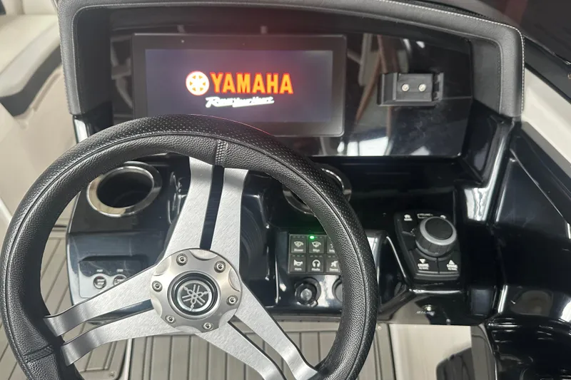 Slide: The Image of 2020 Yamaha Boats 242SE dashboard with steering wheel and digital display. - 11