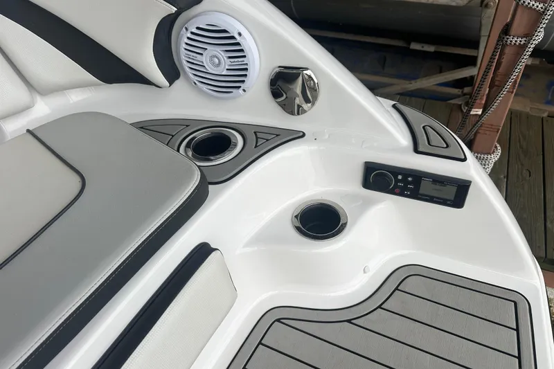 Slide: The Image of 2020 Yamaha Boats 242SE interior with speaker, cup holders, and control panel. - 14